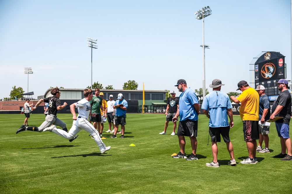 College coaches timing and evaluating players at a Best in the US event